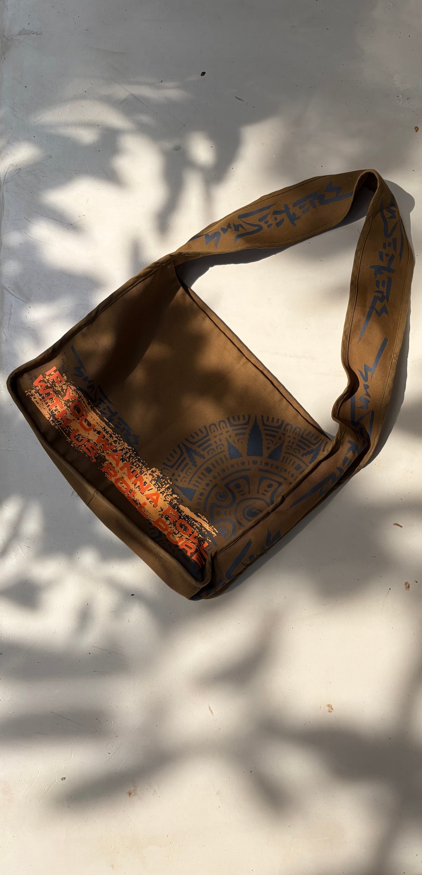 Sunseekers khaki messenger bag with orange interior and printed shoulder strap